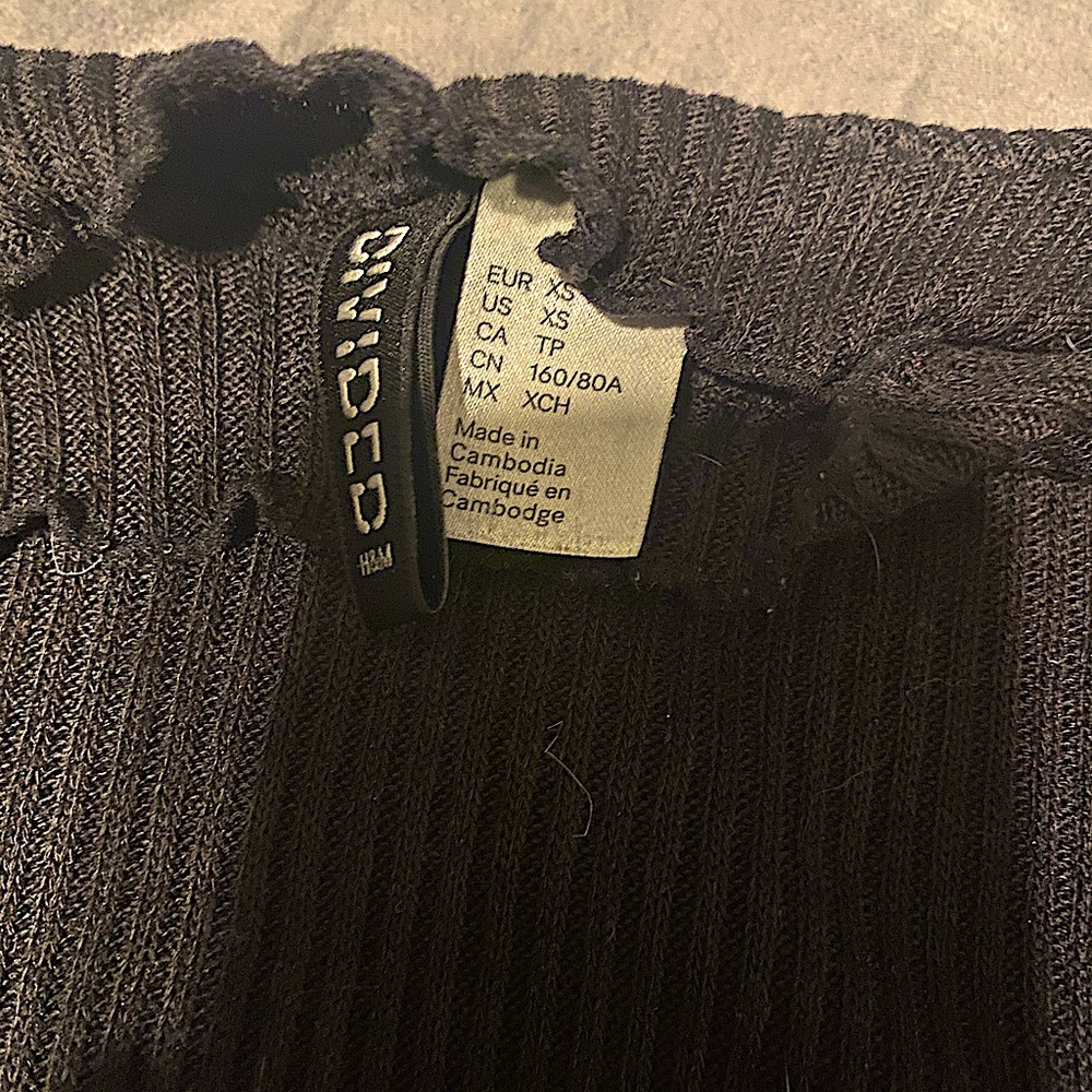 Long sleeve, fitted shirt, with ruffled edges.